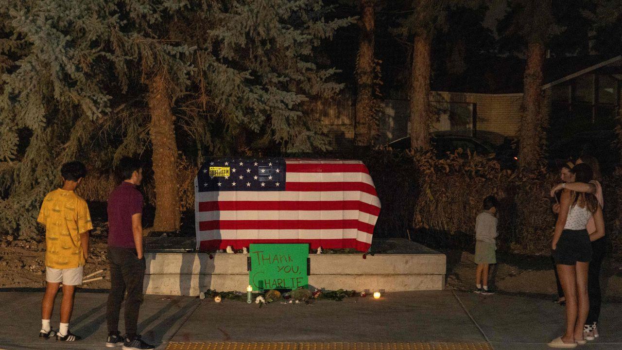 People stand by a makeshift memorial in honor of youth activist and influencer Charlie Kirk